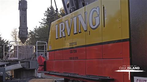 Yellow and red Irving Equipment crawler crane at work on the TV series The Curse of Oak Island