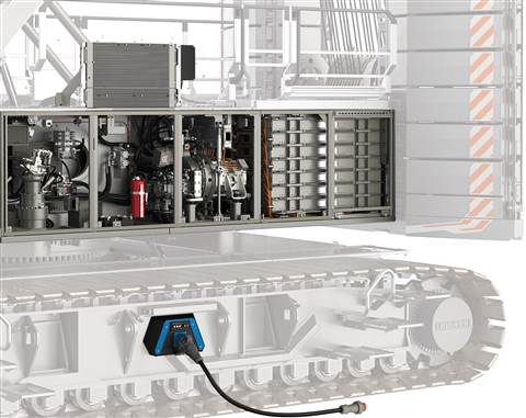 The left side of the machine showing the battery pack towards the rear, with the main drive motor and pumps ahead of it. Standing at the front of the compartment is the slewing motor